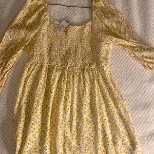 A beautiful yellow flower dress with a cute spice with off and on the shoulder.